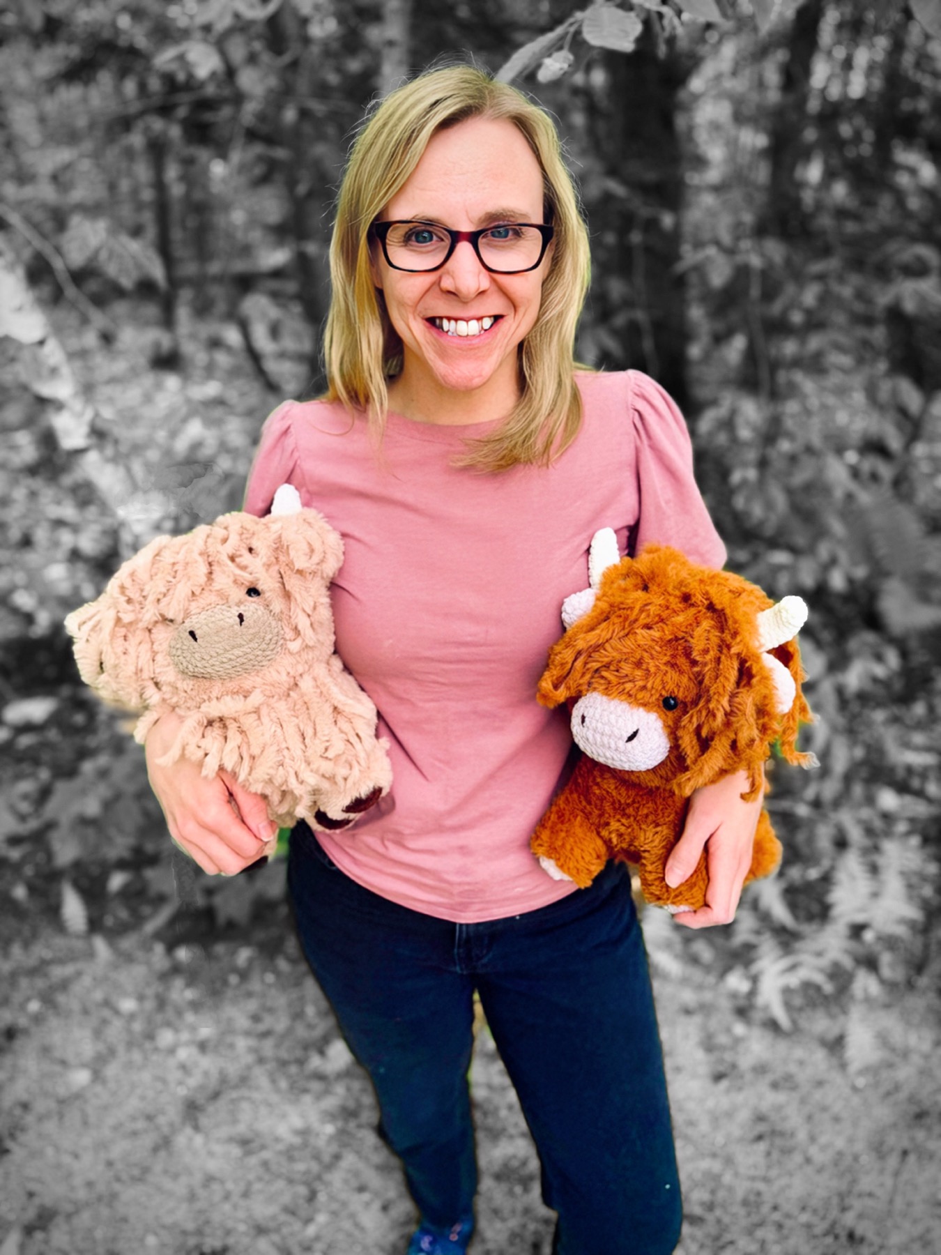 Krissy holding two handmade cow amigurumi dolls